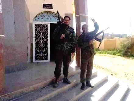 Libyan army soldiers stand at the entrance of Sheherazade Hall, Old Leithi, east Benghazi, just after its liberation from jihadist cutthroats