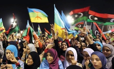 Libyan women waving the new Libyan flag and the flag of the Amazigh people – often called Berbers – during an Amazigh festival in Tripoli, 27 September 2011