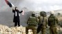 Palestinian woman confronts soldiers