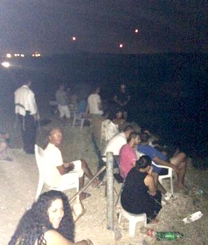 Israelis bring chairs to a hilltop in Sderot, on the border with Gaza, to watch their air force strike Palestinian civilians, clapping and cheering when they hear the bomb blasts