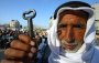 Palestinian man holds the key to his usurped home, as a symbol of the right of return