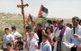 Palestinian Christians holding a cross and a Palestinian flag